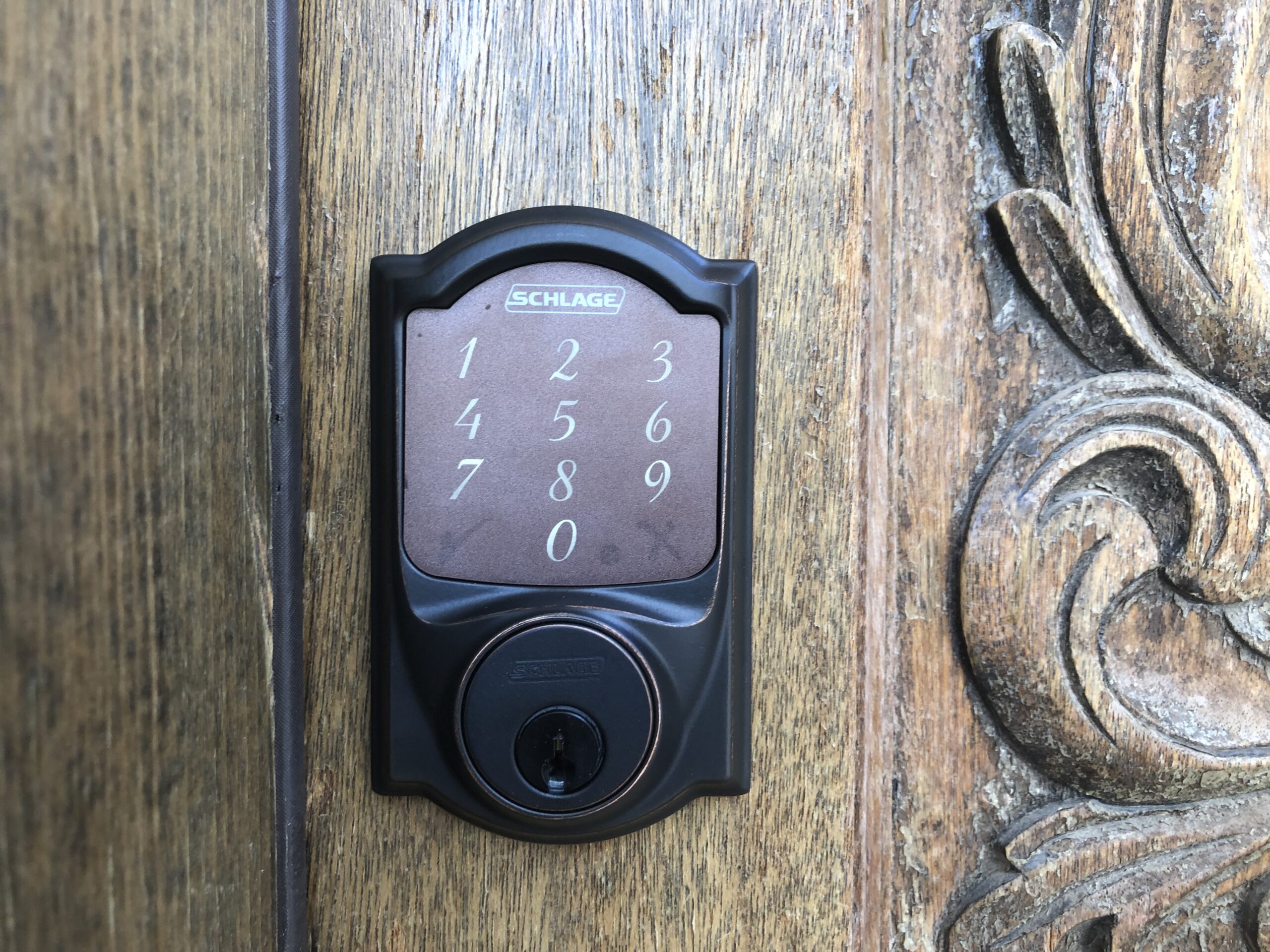 new deadbolt and doorknob lock installed on a residential front door.