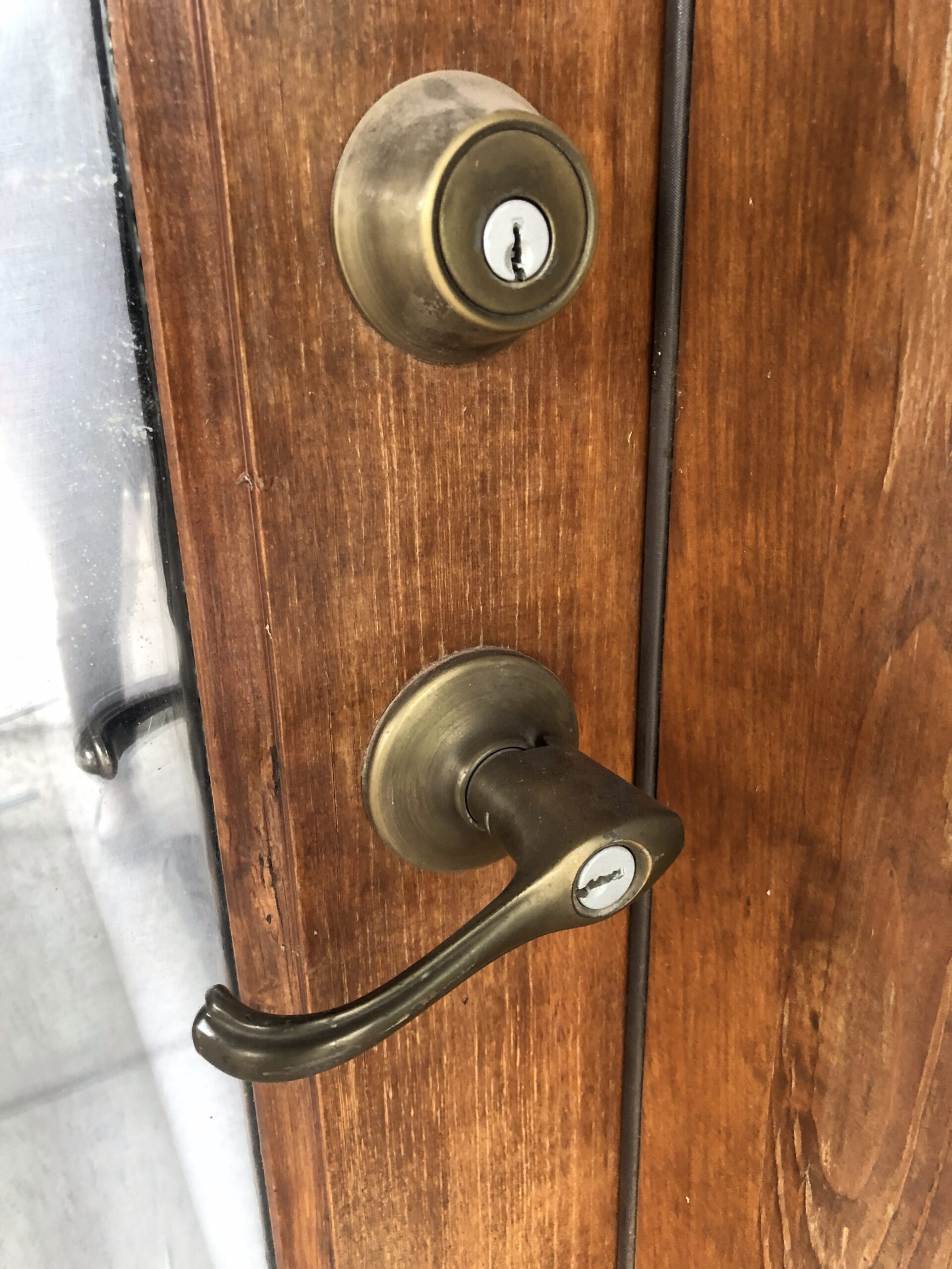 new deadbolt and doorknob lock installed on a residential front door.